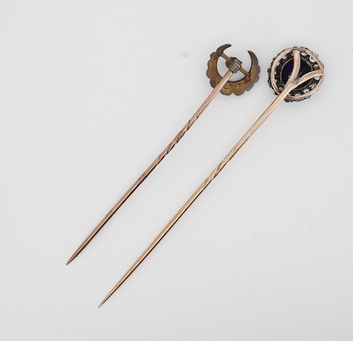 A late Victorian yellow metal, blue paste and diamond cluster set stick pin, 68mm, together with a 15ct, diamond and seed pearl set crescent stick pin. Condition - poor to fair